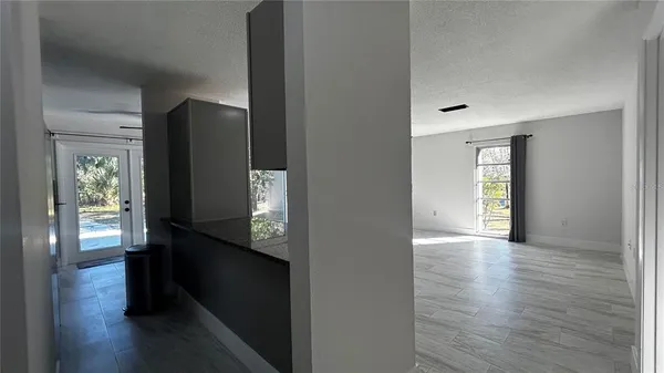 a view of hallway with stairs and wooden floor