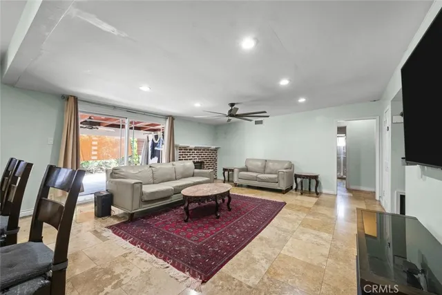 a living room with furniture wooden floor and a flat screen tv