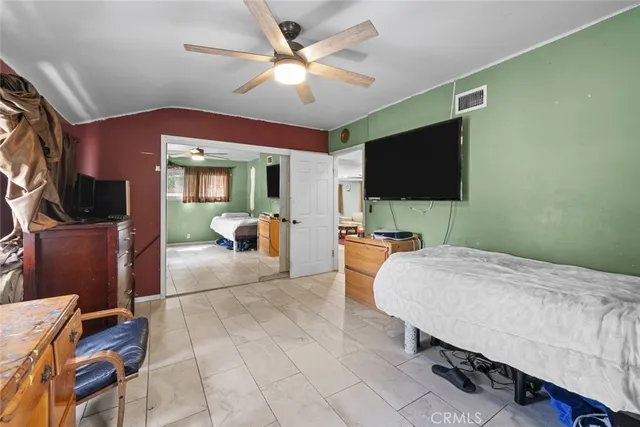 a bedroom with furniture and a flat screen tv