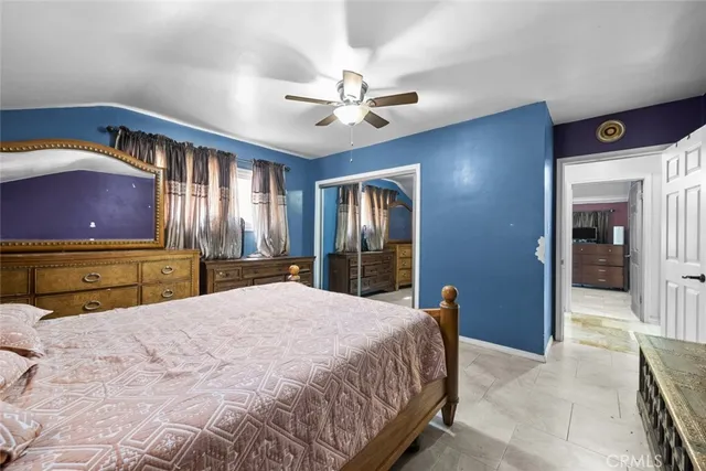 a bedroom with a large bed and a chandelier