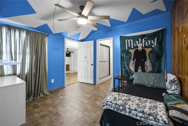 a bedroom with a bed and a mirror