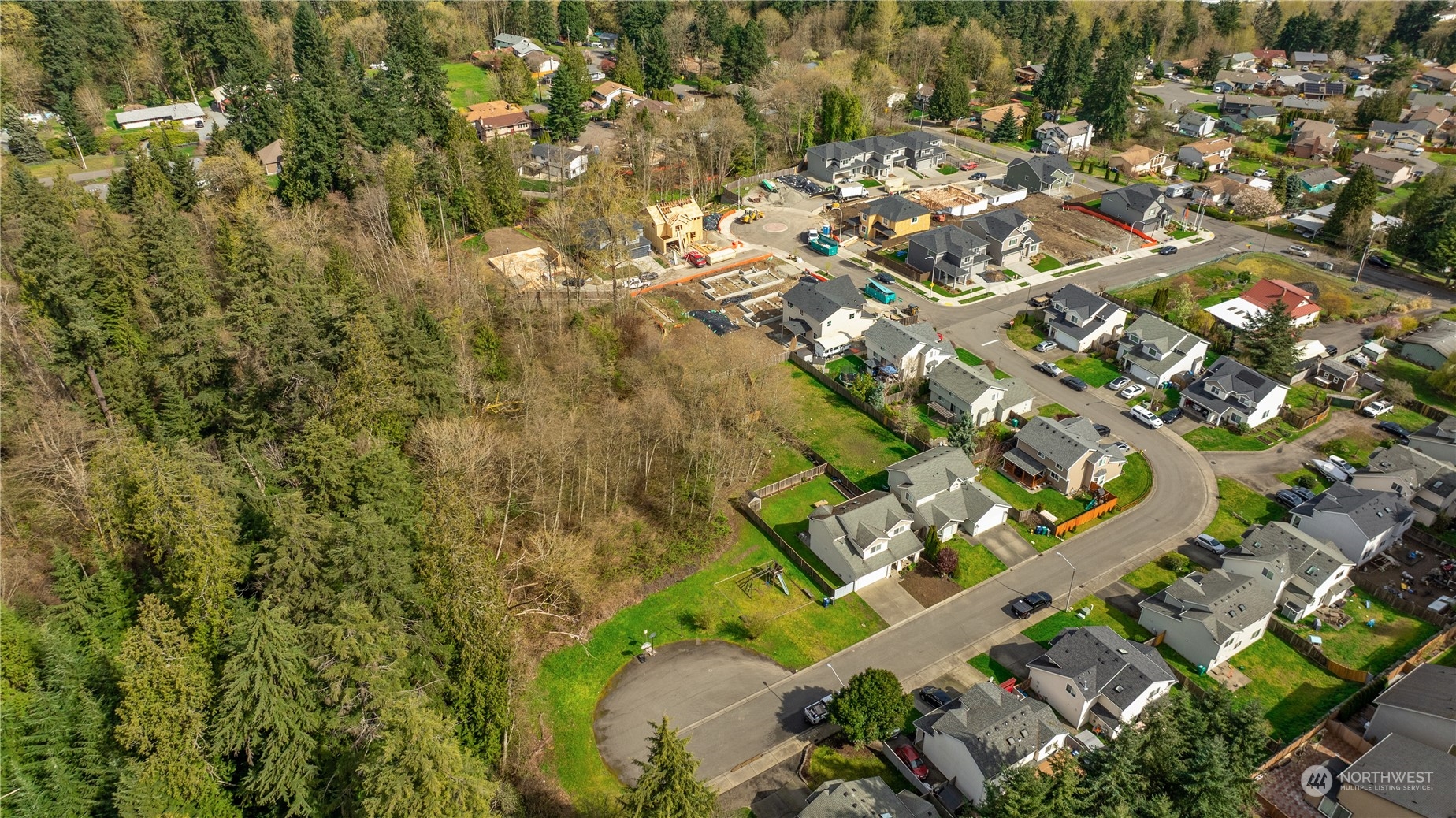 an aerial view of a residential houses with yard