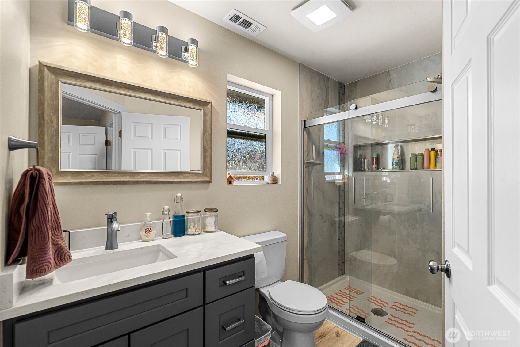 3577 Bainard Road Malaga, WA 98828 - Photo 13 of 39 a bathroom with a sink a toilet a mirror and shower