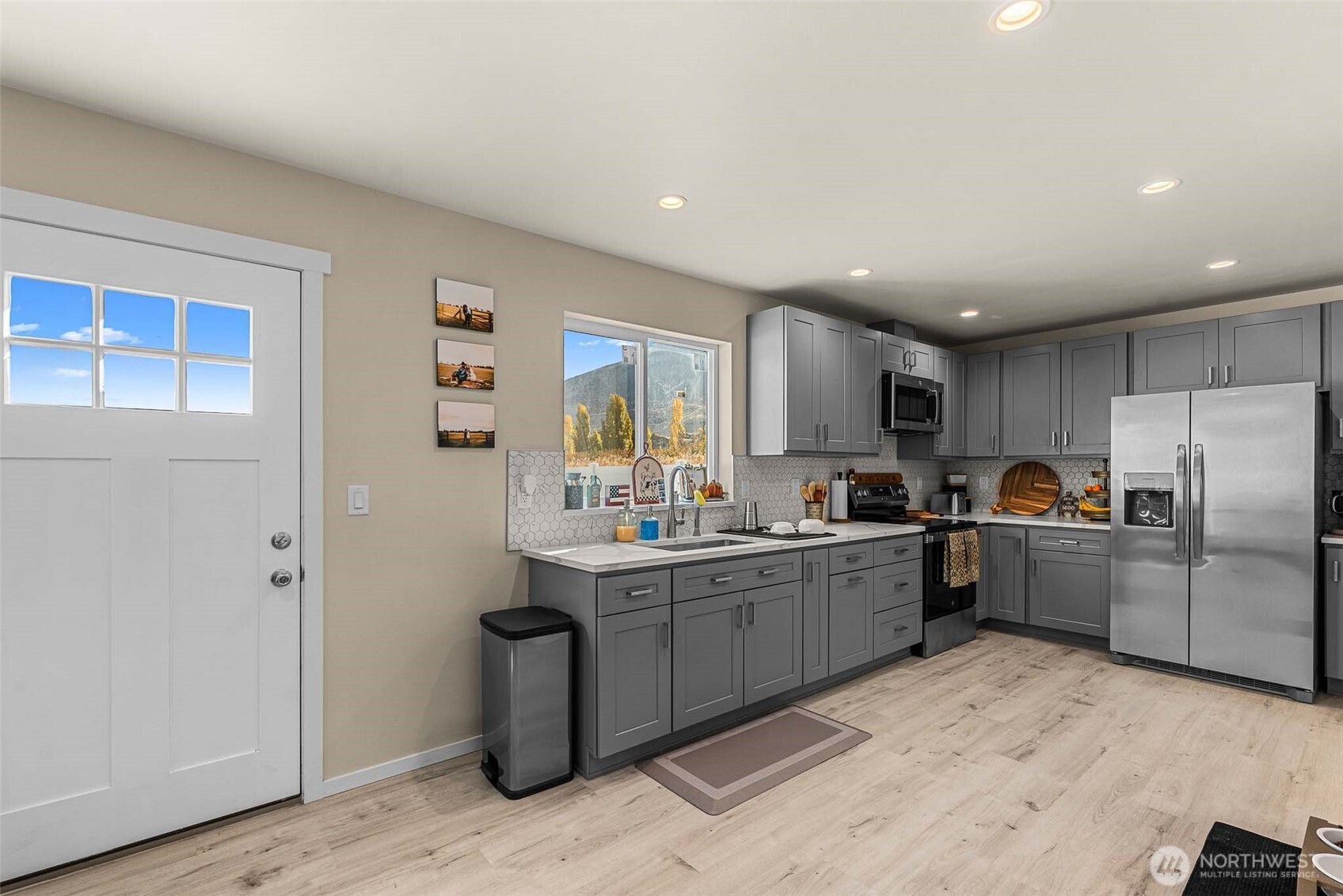 3577 Bainard Road Malaga, WA 98828 - Photo 24 of 39 a kitchen with refrigerator and cabinets