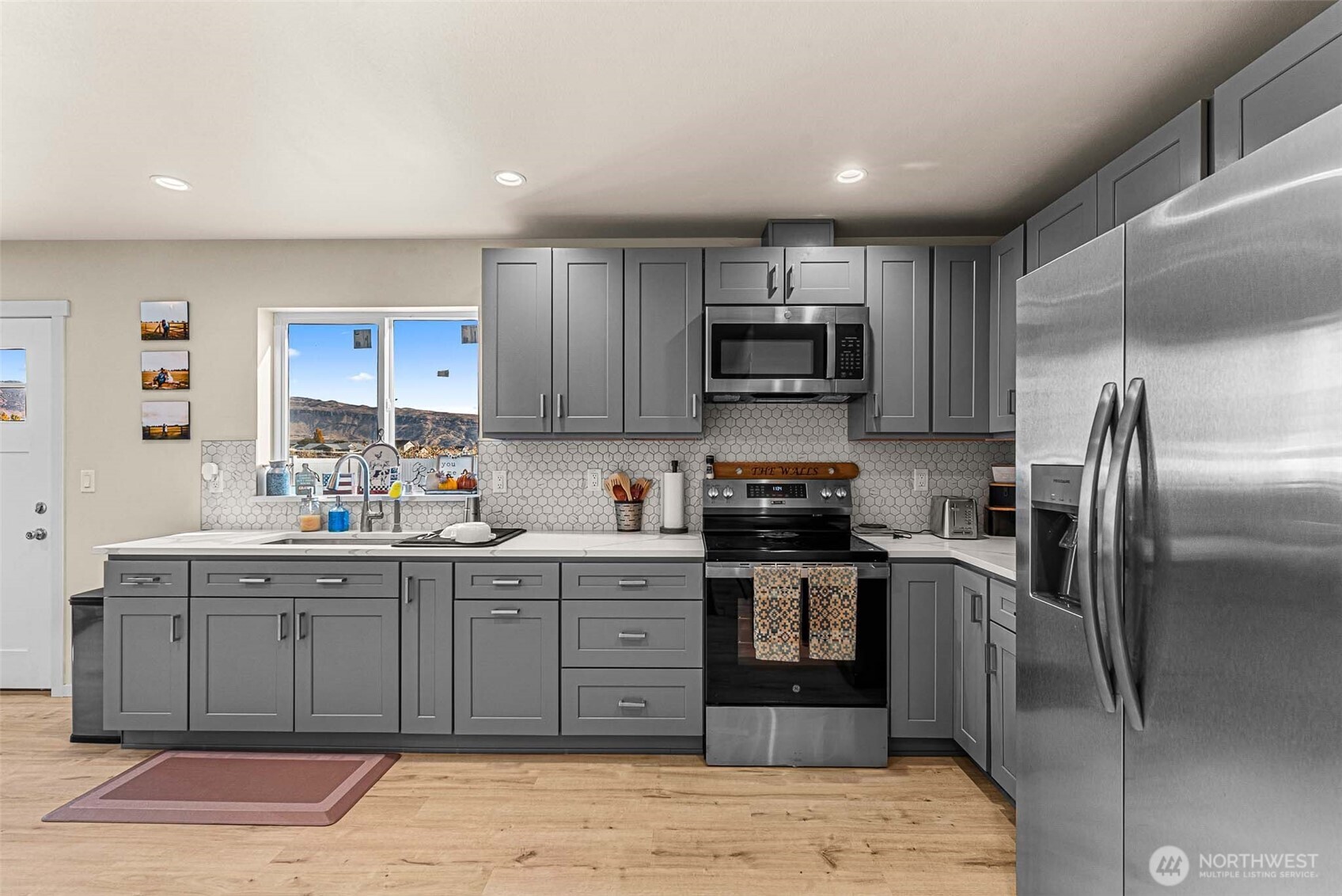 3577 Bainard Road Malaga, WA 98828 - Photo 25 of 39 a kitchen with stainless steel appliances granite countertop a stove top oven a sink and dishwasher
