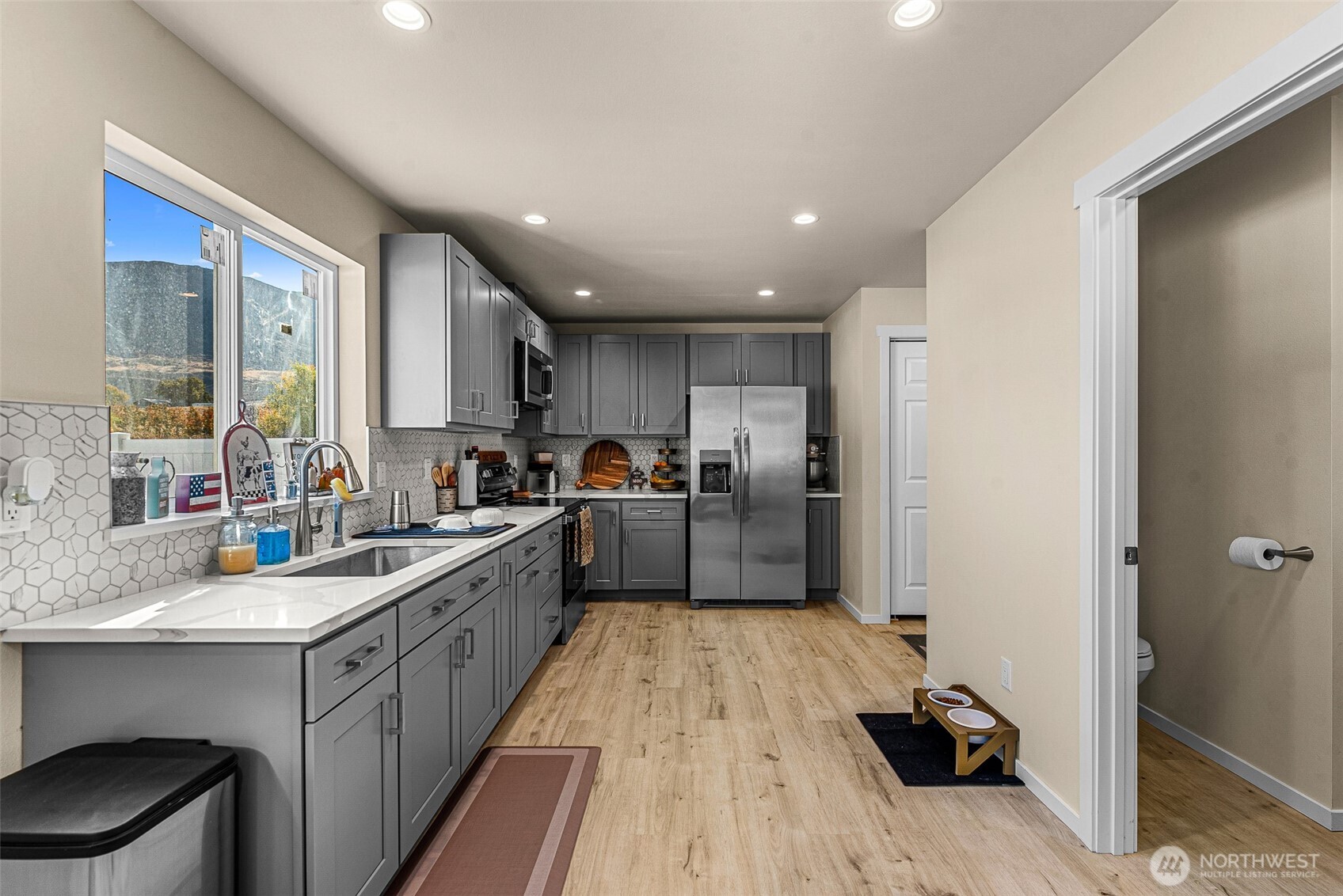 3577 Bainard Road Malaga, WA 98828 - Photo 26 of 39 a kitchen with sink refrigerator and cabinets