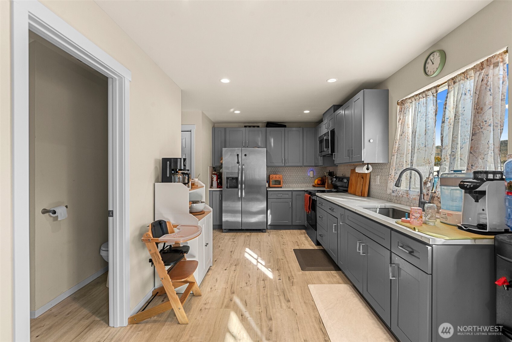 3577 Bainard Road Malaga, WA 98828 - Photo 8 of 39 a large white kitchen with lots of counter space and windows