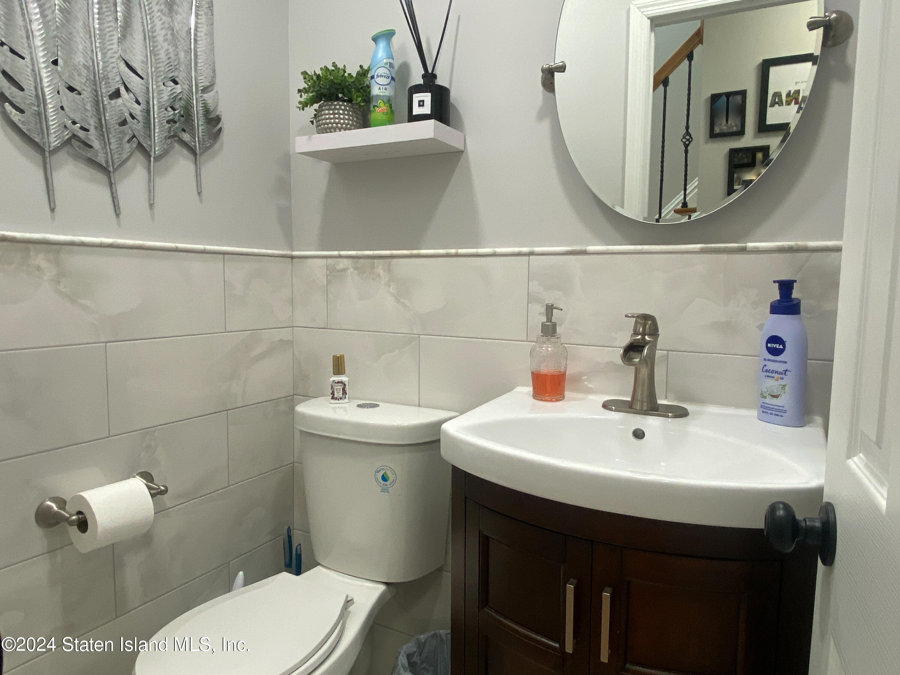 1440 Forest Hill Road, Unit 2 Staten Island, NY 10314 - Photo 12 of 32 a bathroom with a sink and a mirror