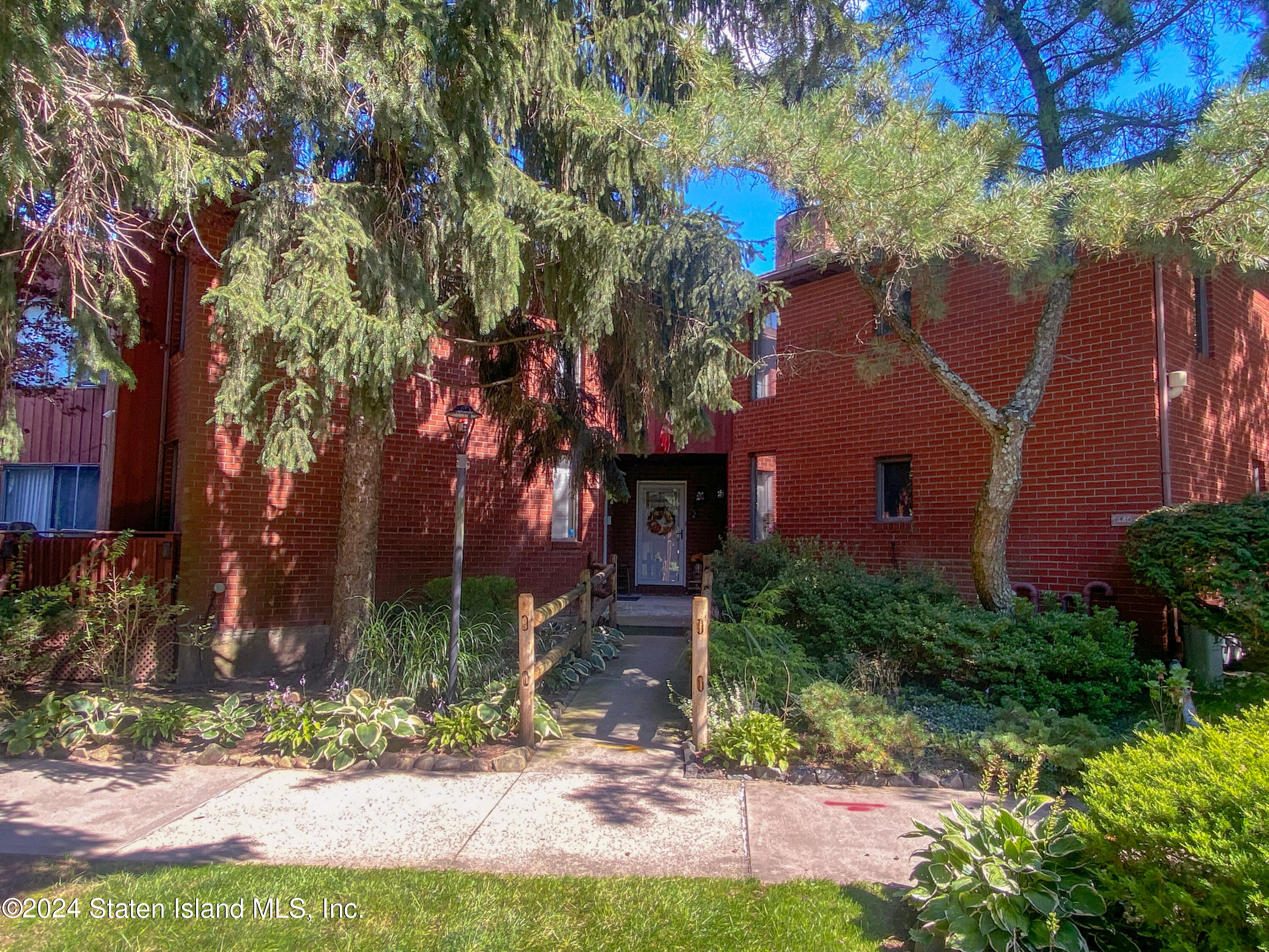 1440 Forest Hill Road, Unit 2 Staten Island, NY 10314 - Photo 2 of 32 a front view of a house with garden