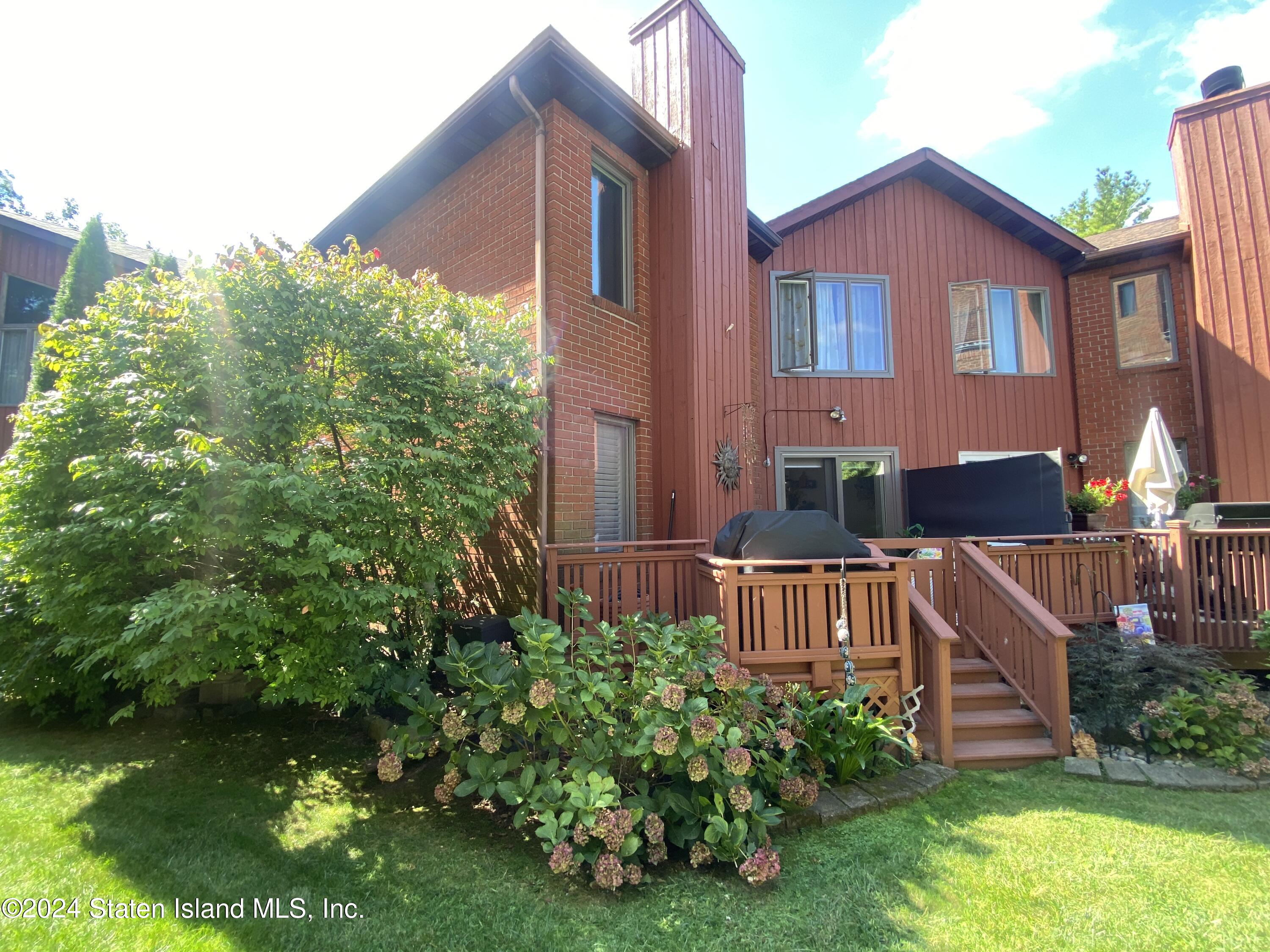 1440 Forest Hill Road, Unit 2 Staten Island, NY 10314 - Photo 27 of 32 a front view of a house with garden
