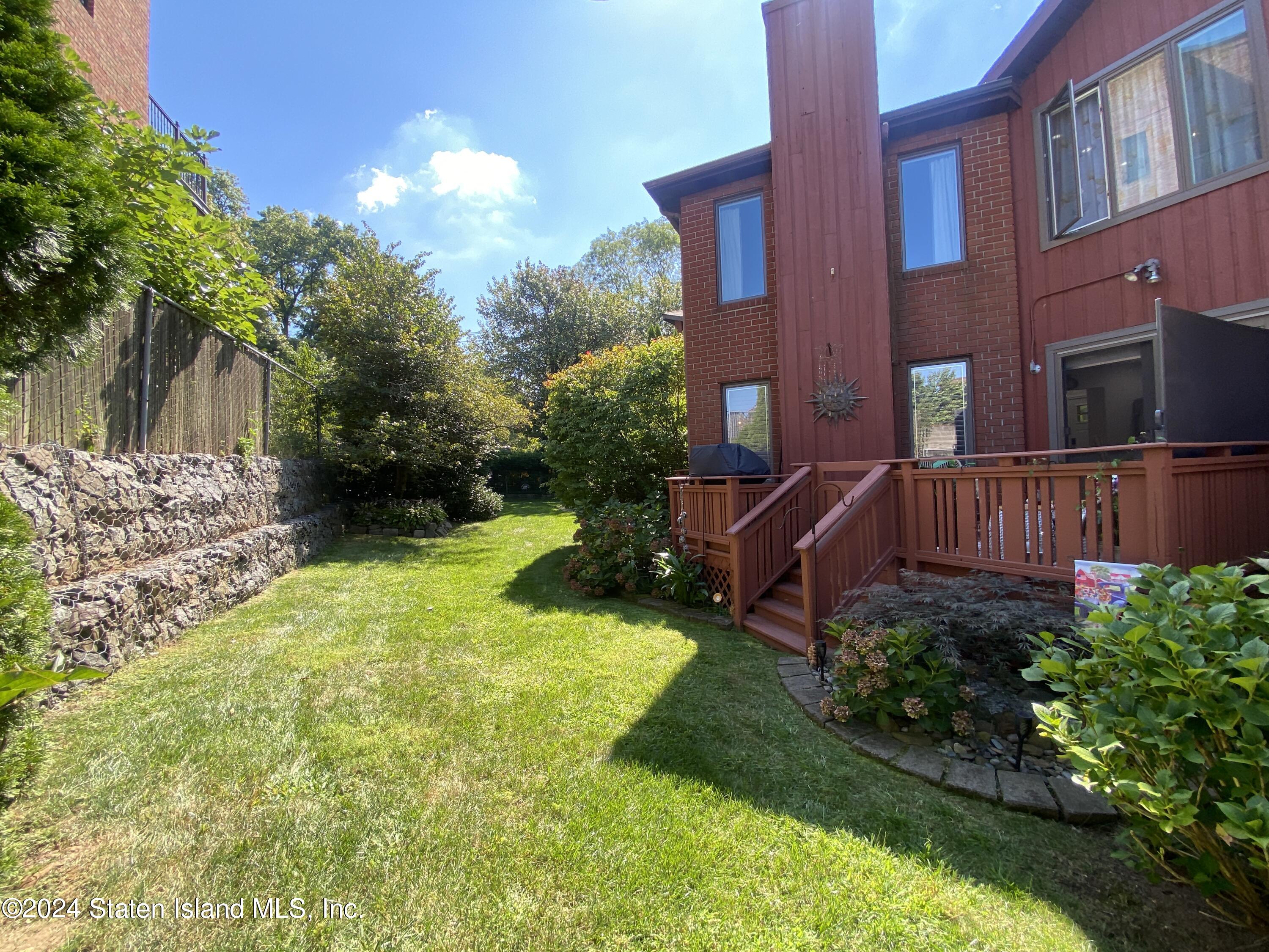 1440 Forest Hill Road, Unit 2 Staten Island, NY 10314 - Photo 28 of 32 a view of a house with a yard