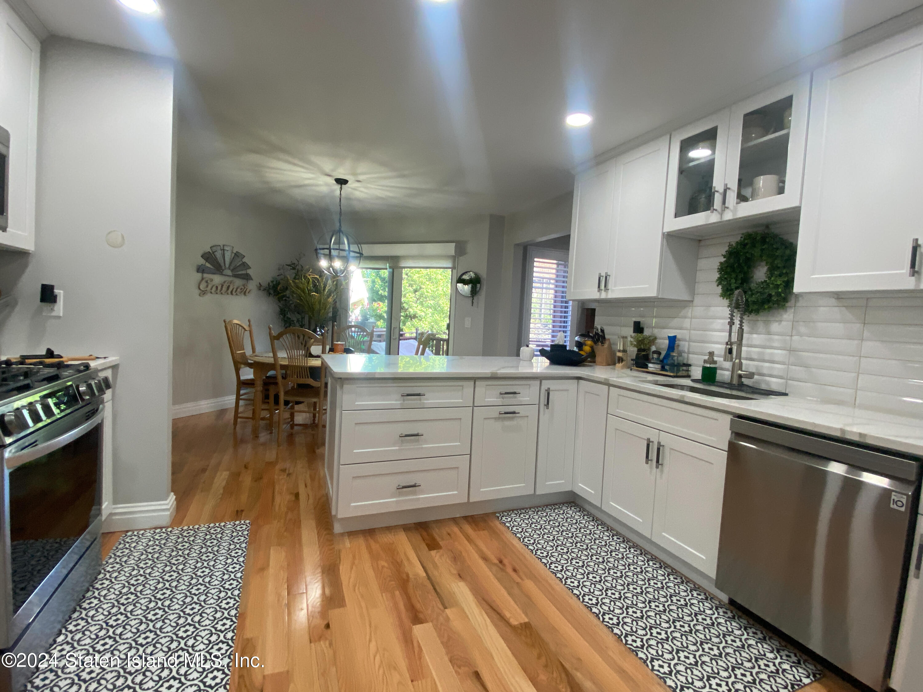 1440 Forest Hill Road, Unit 2 Staten Island, NY 10314 - Photo 5 of 32 a kitchen with a sink and wooden floor