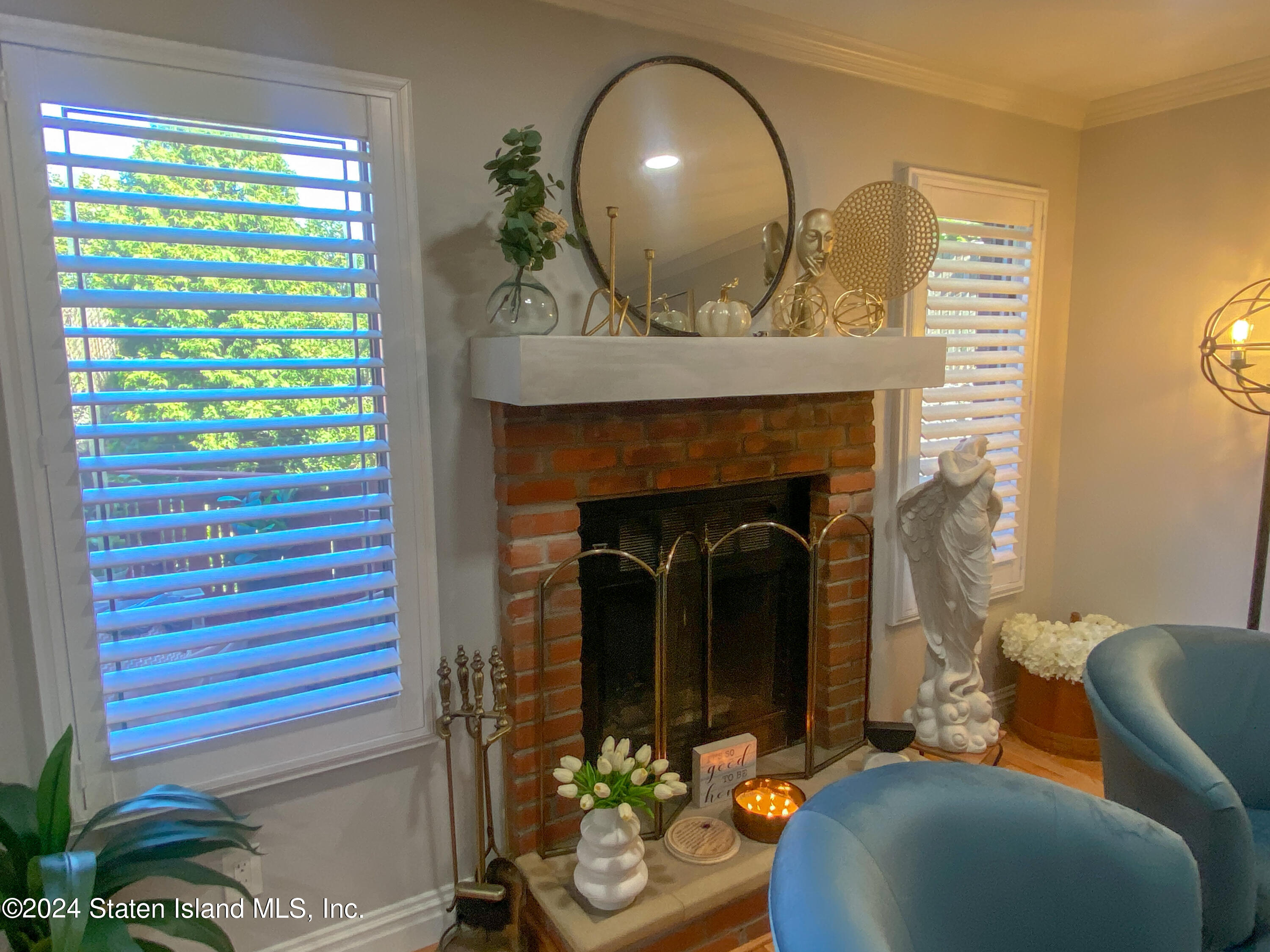 1440 Forest Hill Road, Unit 2 Staten Island, NY 10314 - Photo 9 of 32 a living room with furniture and a fireplace