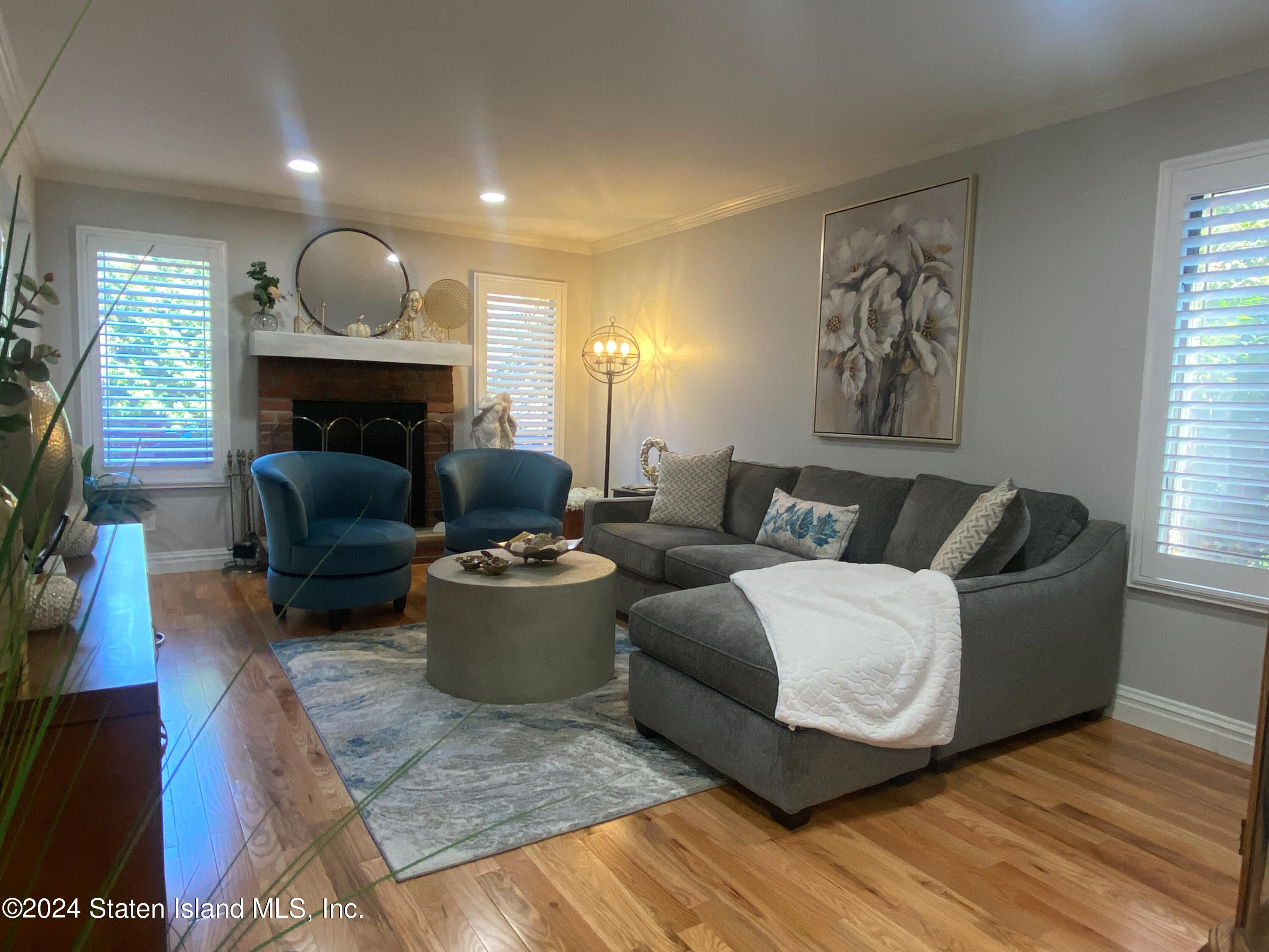 1440 Forest Hill Road, Unit 2 Staten Island, NY 10314 - Photo 10 of 32 a living room with furniture and a fireplace