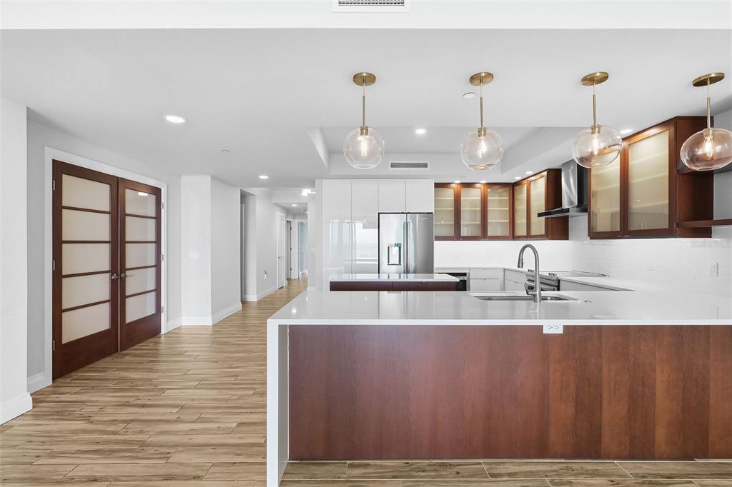 800 Collany Road, Unit 302 St. Petersburg, FL 33715 - Photo 13 of 66 a large kitchen with kitchen island a sink stainless steel appliances and cabinets