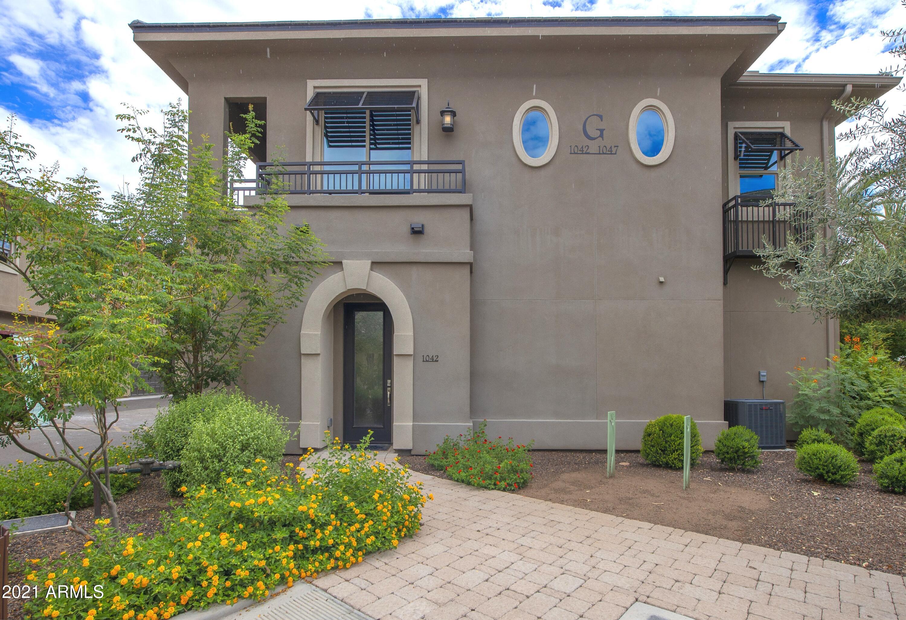 6565 East Thomas Road, Unit 1042 Scottsdale, AZ 85251 - Photo 1 of 22 a front view of a house with garden