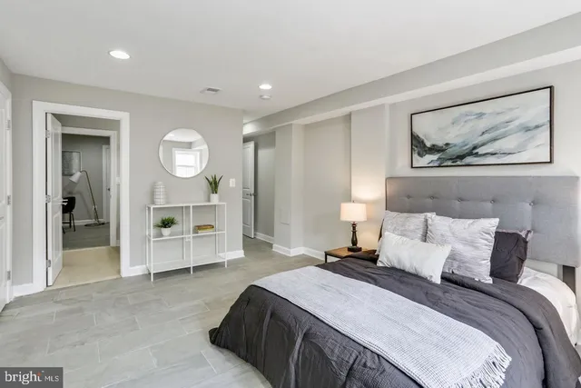 a bedroom with a bed and a painting on the wall