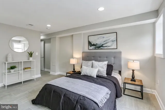 a bedroom with a bed and a lamp