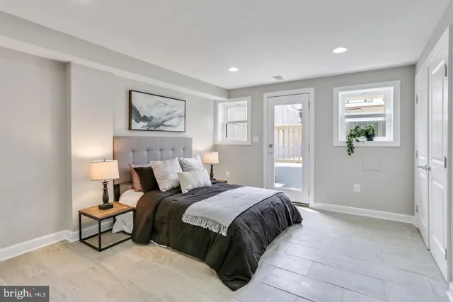 a bedroom with a bed and a painting on the wall