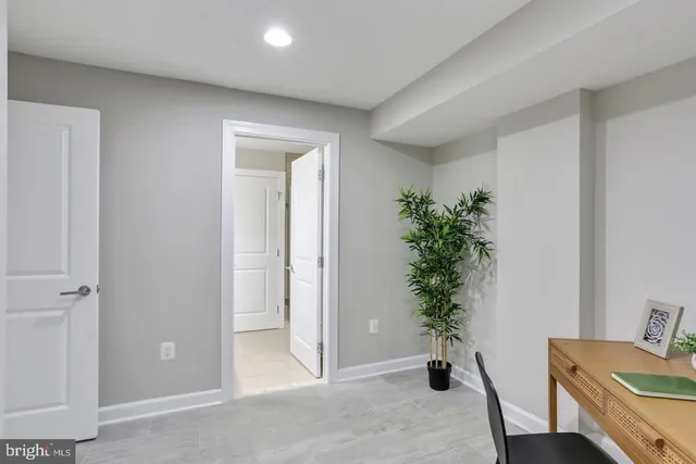 a view of a hallway to a livingroom with furniture