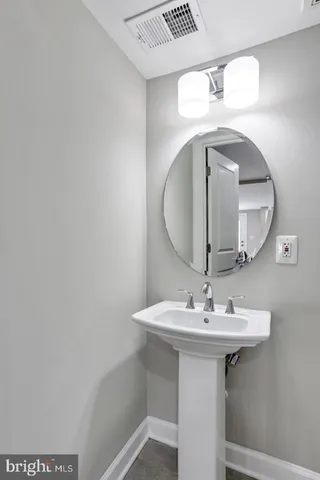 a bathroom with a sink a mirror and vanity