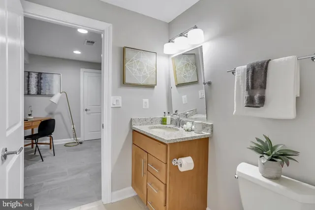 a hallway with a sink and a mirror