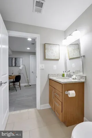 a spacious bathroom with a sink a mirror and a toilet