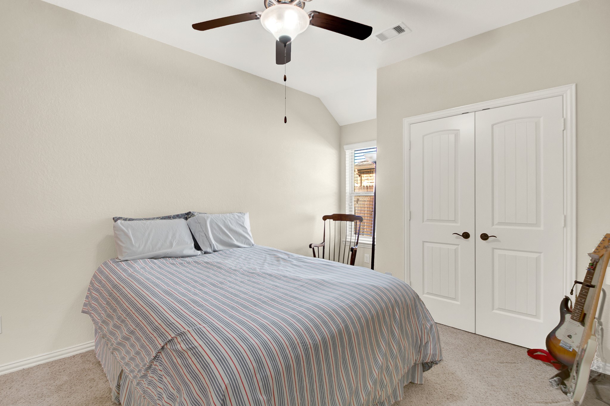 3864 Oakmist Bend Lane Spring, TX 77386 - Photo 26 of 38 a bedroom with a bed and a chandelier