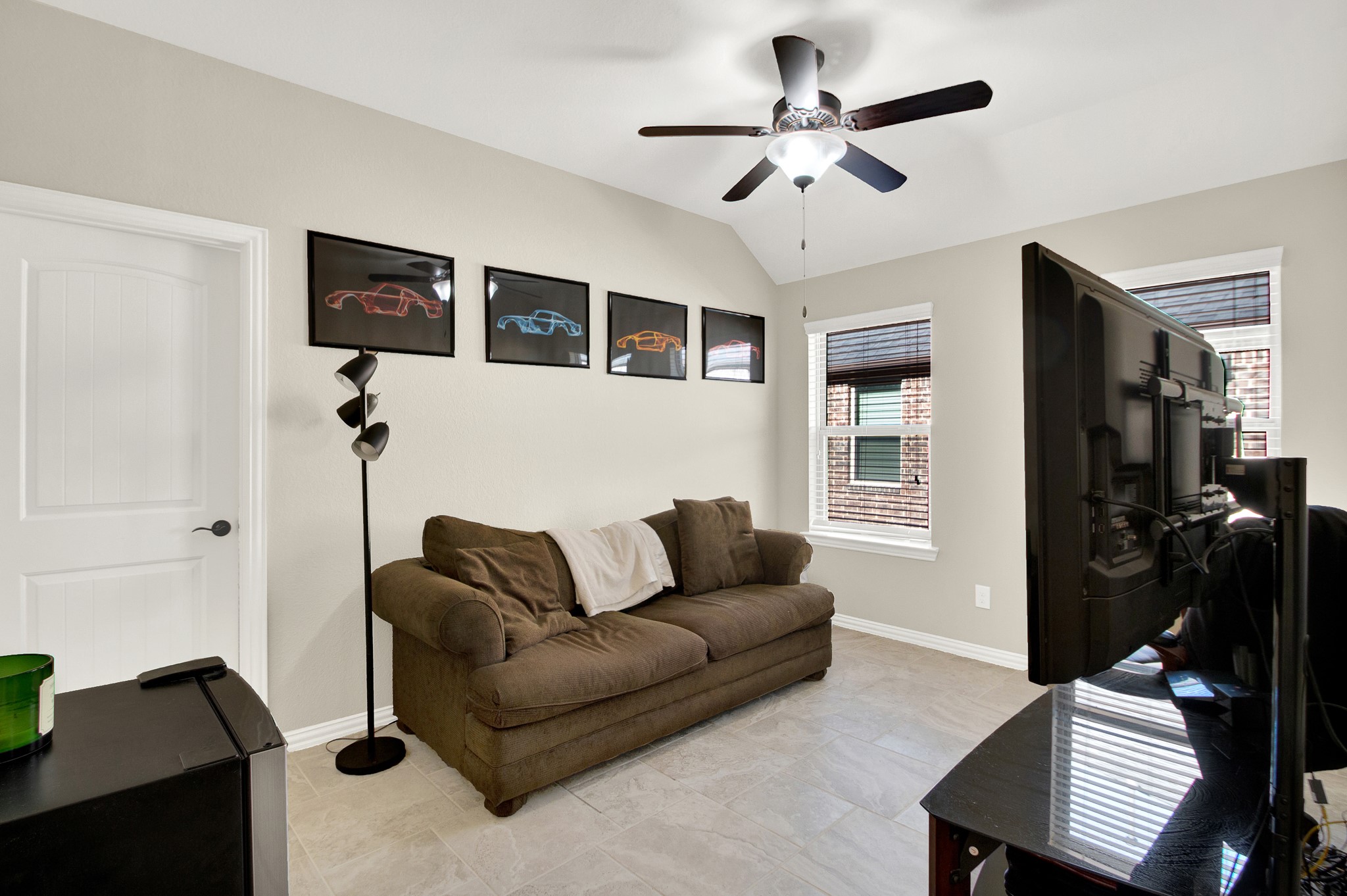 3864 Oakmist Bend Lane Spring, TX 77386 - Photo 27 of 38 a living room with furniture a ceiling fan and a window