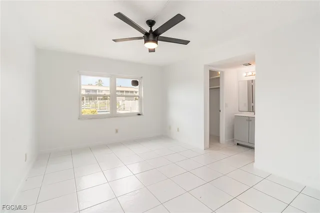 a view of a livingroom with a ceiling fan and window