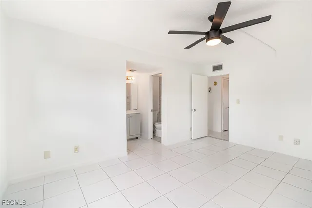 a view of a room with a ceiling fan and a window