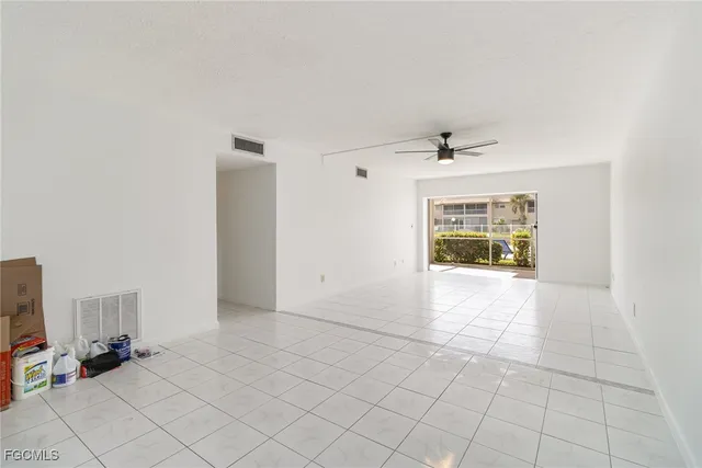 a kitchen with granite countertop white cabinets and a sink