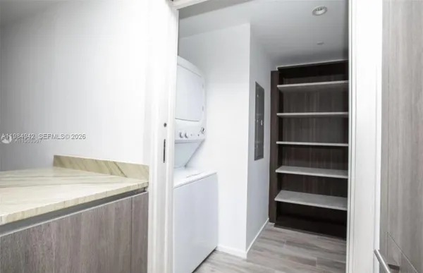 a kitchen with granite countertop a sink and cabinets