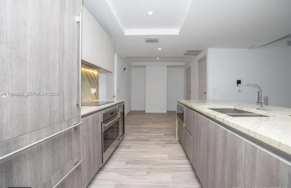 a view of hallway with wooden floor