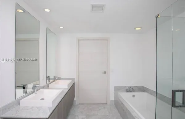 a spacious bathroom with a bathtub and a shower