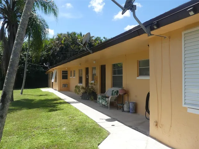 a backyard of a house with yard and outdoor seating