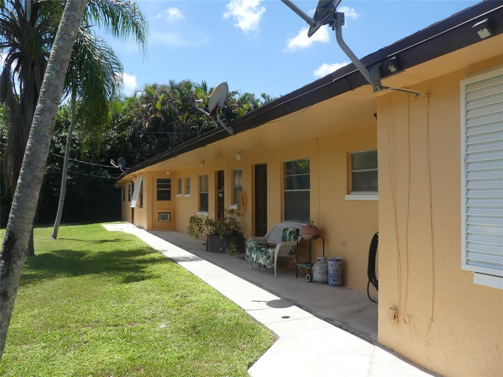 4725 Southwest 65th Avenue Davie, FL 33314 - Photo 3 of 14 a backyard of a house with yard and outdoor seating