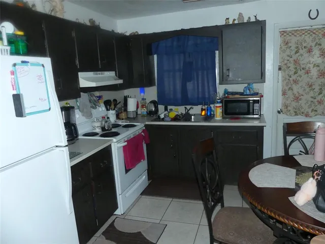 a kitchen with a sink stove and refrigerator
