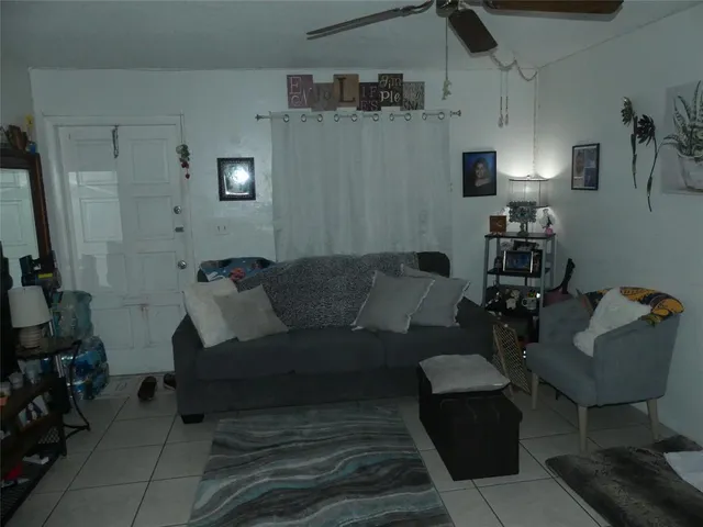 a living room with furniture and a mirror