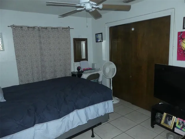 a bedroom with a bed and a flat tv screen on the table
