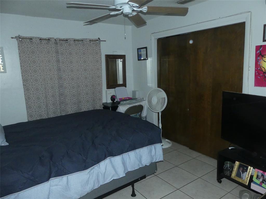 4725 Southwest 65th Avenue Davie, FL 33314 - Photo 7 of 14 a bedroom with a bed and a flat tv screen on the table
