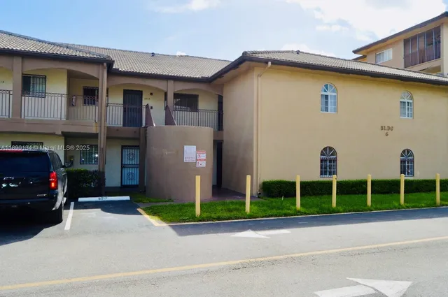 a view of a house with a yard and a street