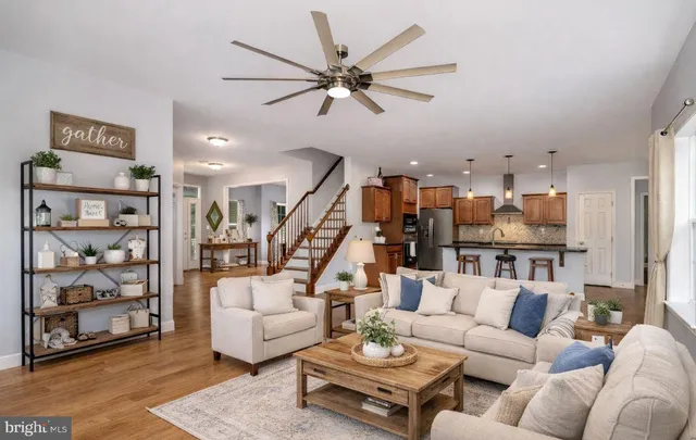 a view of empty room with wooden floor and windows