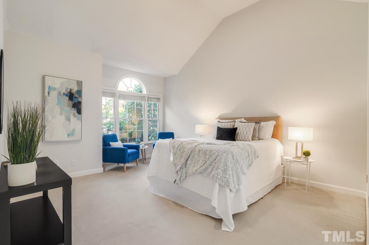 2116 Fountain Ridge Road Chapel Hill, NC 27517 - Photo 13 of 27 a spacious bedroom with a bed and a couch
