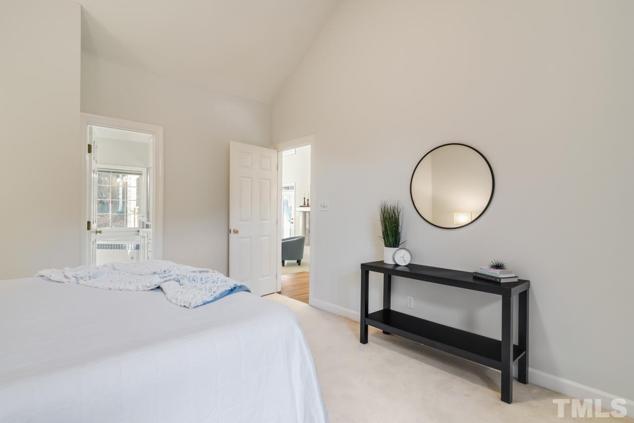2116 Fountain Ridge Road Chapel Hill, NC 27517 - Photo 15 of 27 a bedroom with a bed and a mirror