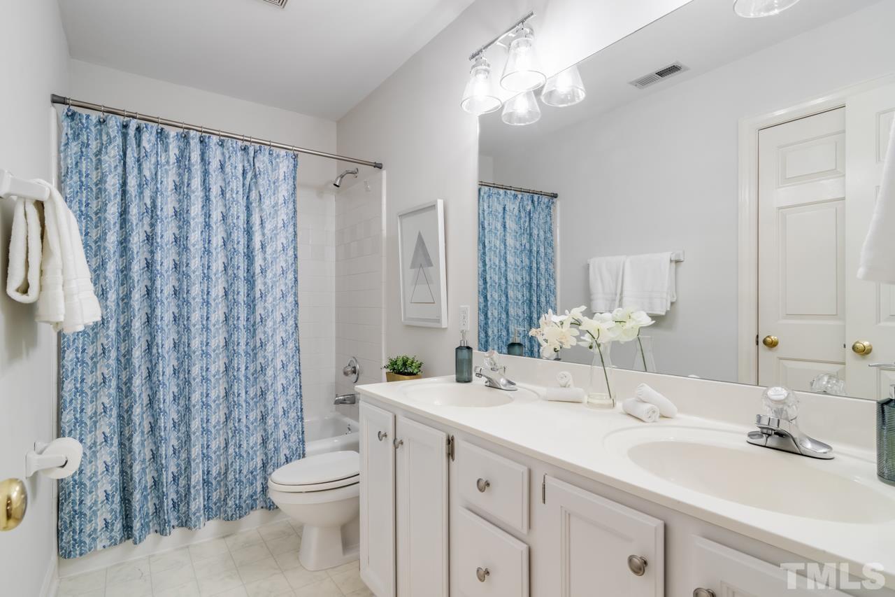 2116 Fountain Ridge Road Chapel Hill, NC 27517 - Photo 23 of 27 a bathroom with a double vanity sink mirror and toilet