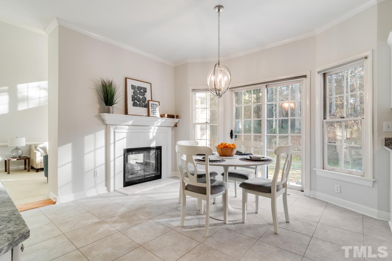 2116 Fountain Ridge Road Chapel Hill, NC 27517 - Photo 5 of 27 a dining room with furniture a fireplace and chandelier