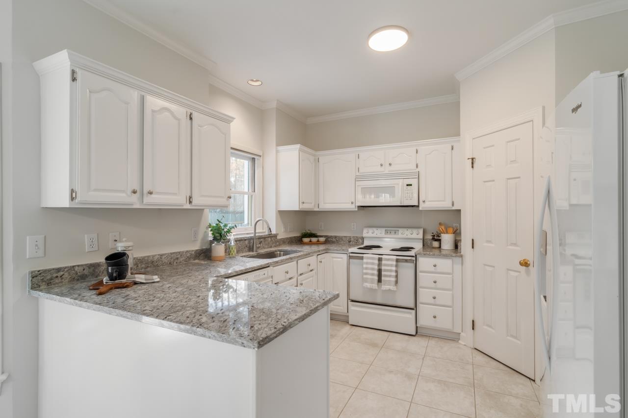 2116 Fountain Ridge Road Chapel Hill, NC 27517 - Photo 8 of 27 a kitchen with stainless steel appliances granite countertop a sink and cabinets with granite countertops