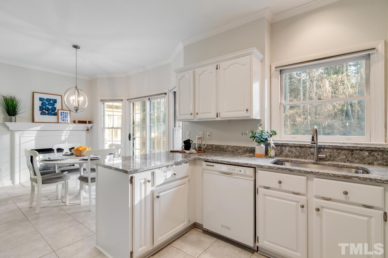 2116 Fountain Ridge Road Chapel Hill, NC 27517 - Photo 9 of 27 a kitchen with a sink stove and cabinets