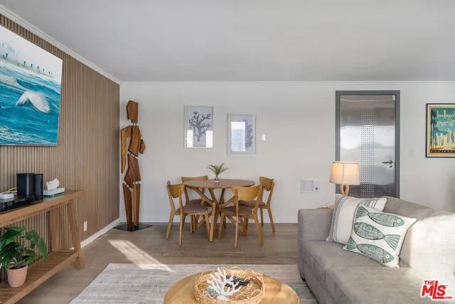 a view of a dining room with furniture a chandelier and wooden floor